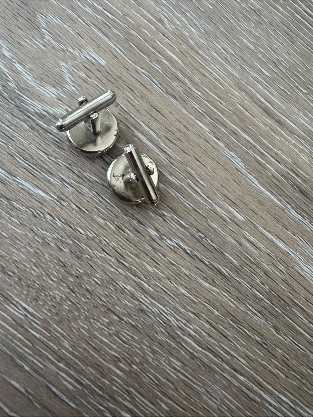 Pink textured cuff links in silver tone metal